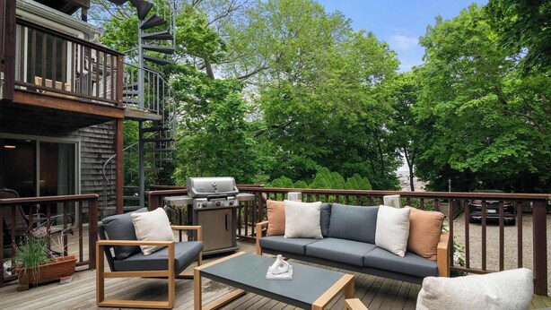 An outdoor deck with a sofa, chairs, a table, and a grill. - Rare Private Deck, Dog Friendly, Walk to Harbor! (Provincetown)
