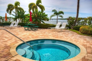 Soak in the bubbling hot tub while gazing across the serene waterfront, where palm trees sway and loungers await your next moment of relaxation. - Pets Welcome, Balcony Hot Tub & Pool! (St. Petersburg)