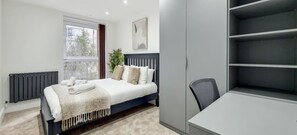 1 bedroom, desk, iron/ironing board, travel crib