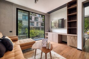 A modern living room with a sofa, coffee table, and built-in shelving.