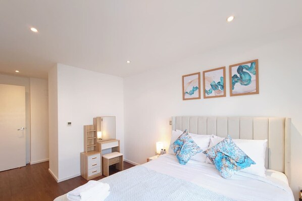3 habitaciones, escritorio y tabla de planchar con plancha