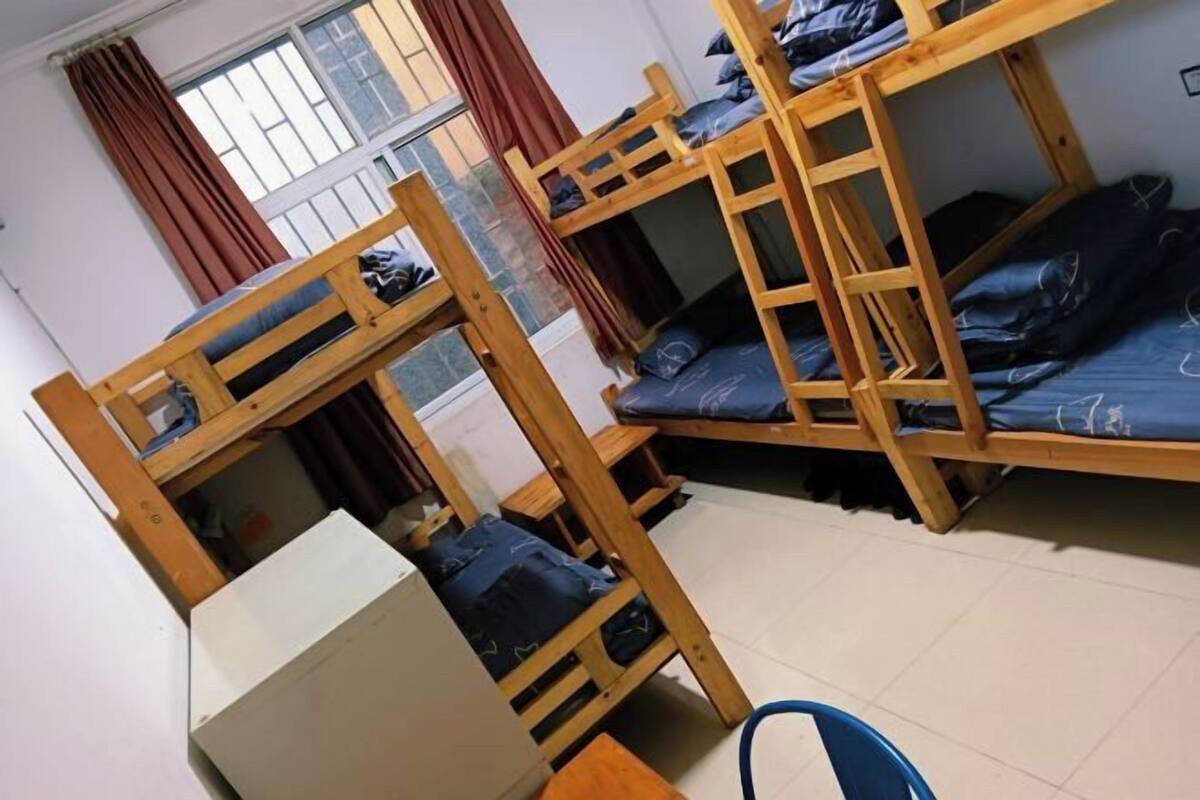 Un dormitorio con literas, un escritorio y una silla.