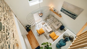 A modern interior with a spiral staircase, a view of the outdoors, and a cozy seating area with a table.