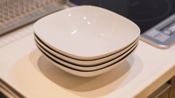 A stack of white plates on a countertop.