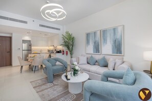 Luxury Apartment, Balcony, Pool View | Living area | 65-inch Smart TV with cable channels - Elegant MJL Pool View Near Burj Al Arab (Dubai)