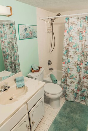 A bathroom with a toilet, sink, and shower. - Ocean Delight 2/2 Sandpoint Condo Great OceanViews Pool, Great Rates (Daytona Beach)