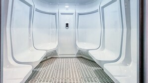 A modern elevator with a metallic floor and a control panel at the top. - Chic Marina Arcade Apartment Minutes to Beach (Dubai)