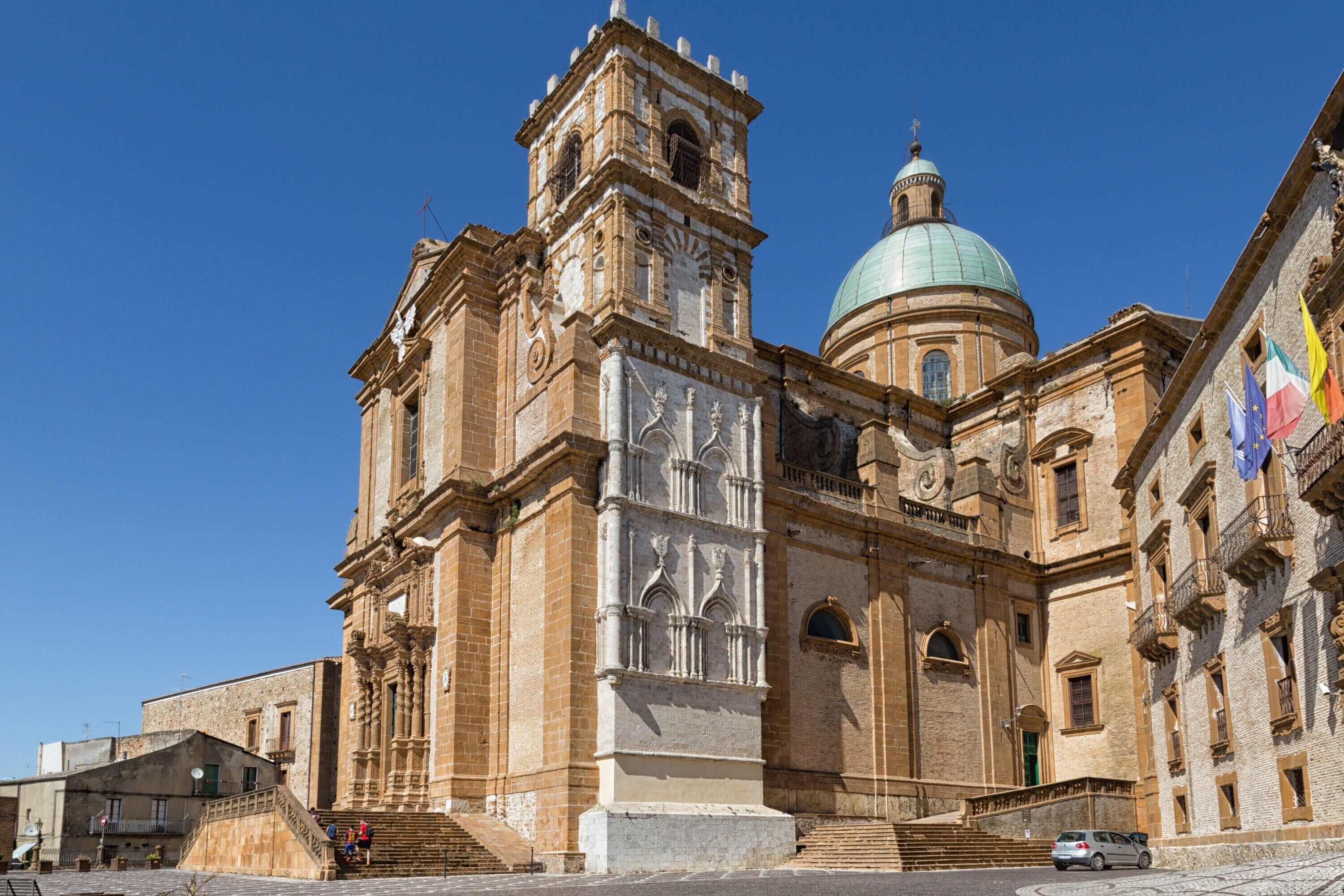 A historic building with a prominent clock tower and a dome.