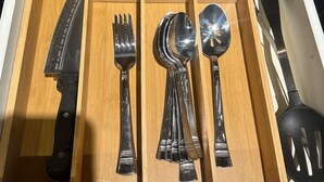 Un tiroir contenant un couteau, une fourchette, une cuillère et une spatule.