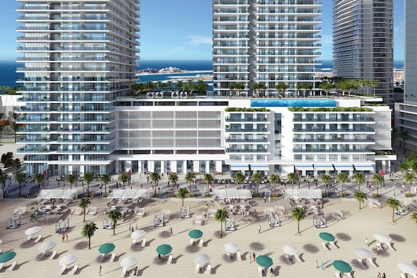 A modern hotel with multiple floors, a rooftop pool, and a beachfront area with sun loungers.