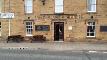 The Eagle Hotel with a signboard indicating it was awarded 'Pub of the Year 2015'.