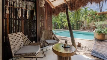 Deluxe Bungalow, Garden View, Poolside | Terrace/patio