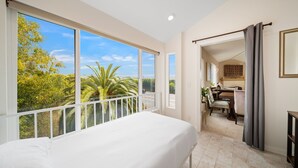 A bedroom with a large window, a balcony, and a view of greenery. - Mins To Beach, Perfect For Families, Amazing Views (Newport Beach)