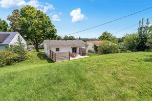 A residential property with a detached house, a fenced yard, and a large tree. - Fun Midcentury Home | Hot Tub | Karaoke | Games (Lancaster)