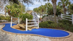 A miniature golf course with a blue putting surface, white railings, and a waterfall feature. - Marriott's Harbour Lake
Charming studio in awesome Orlando (Orlando)