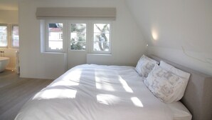 A bedroom with a large bed, a window, and a view of the outside. - Villa in Knokke-heist Near the Beach (Knokke-Heist)