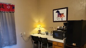 A compact kitchenette with a microwave, coffee maker, and a small trash bin. - John Wayne Suite (Buchanan Dam)