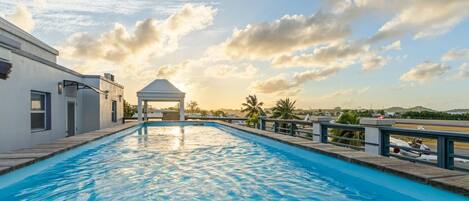 Outdoor pool, open 7:00 AM to 9:00 PM, pool loungers