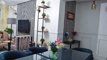 Family Apartment, City View | Living area | 32-inch Smart TV with digital channels