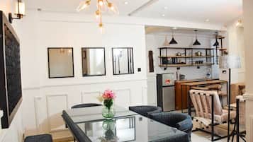 Family Apartment, City View | Living area | 32-inch Smart TV with digital channels