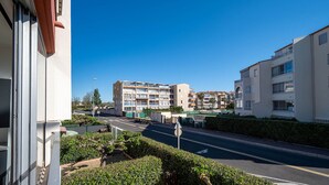 A residential area with multi-story apartment buildings, a clear road, and a well-maintained hedge in the foreground. - Apartment in Agde Near Beach & Heated Pool (Agde)