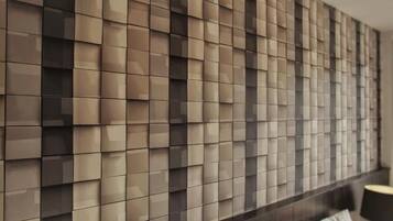 A modern wall with a geometric pattern of square panels.