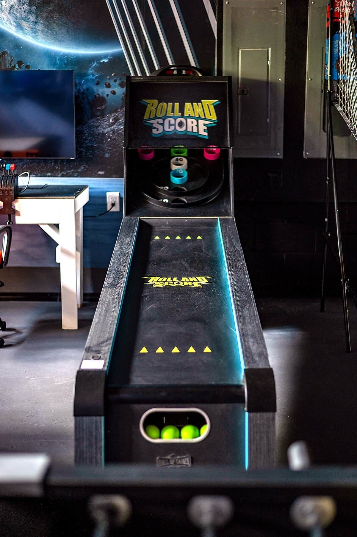 A pinball machine titled 'Roll and Score' with a track, bumpers, and a score display.