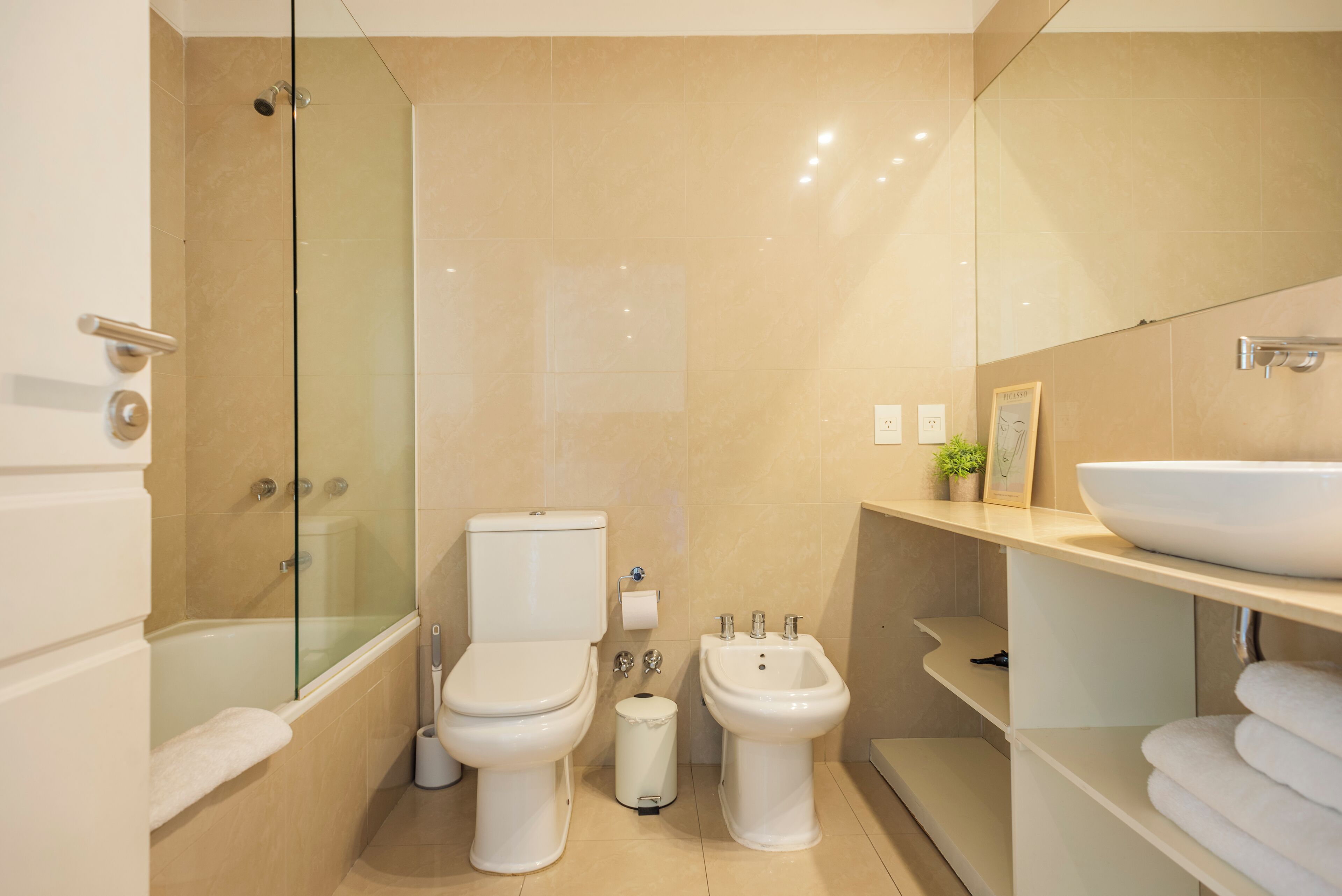 Ein modernes Badezimmer mit Duschkabine, Toilette, Bidet und Waschbecken.