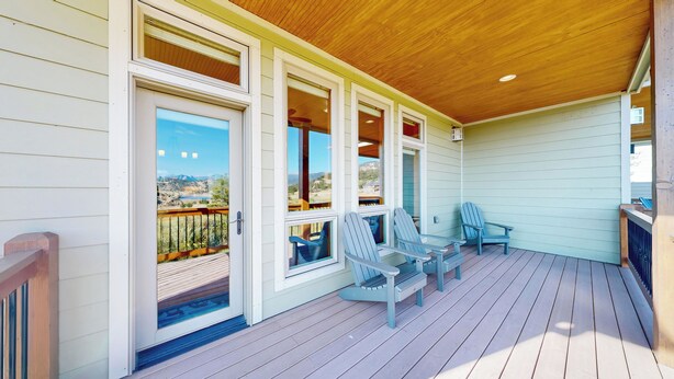 A covered porch with a wooden ceiling, a view of a mountainous landscape, and two Adirondack chairs. - Modern Mountain Retreat/Incredible Mountain Views/Stylish Kitchen/Spotless (Estes Park)