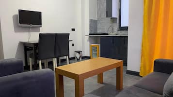 Family Apartment, City View | Living area | 55-cm TV with satellite channels