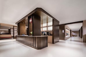 A modern hotel lobby with a reception desk, a seating area, and a bar. - Intercity Hotel Shanghai Hongqiao Airport (Shanghai)