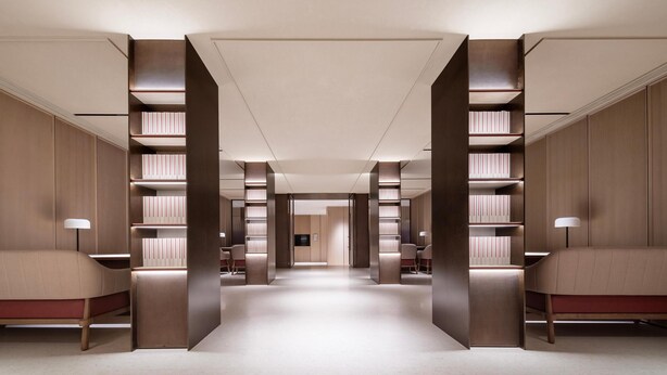 A modern hotel lobby with a central walkway, wooden paneling, and bookshelves on either side. - Intercity Hotel Shanghai Hongqiao Airport (Shanghai)