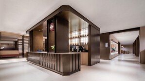 A modern hotel lobby with a reception desk, a seating area, and a bar. - Intercity Hotel Shanghai Hongqiao Airport (Shanghai)