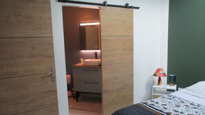 A bedroom with a bed, a bedside table, a lamp, and a wardrobe with a mirror. - House in the hollow of the Embryenne valley. (Boubers les hesmond (62990))