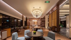 A spacious lobby with a large chandelier, comfortable seating, and a reception area. - Madison Hot Spring Hotel Jian Wugong Mountain (Ji'an)