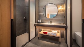 A modern bathroom with a large mirror, a wooden vanity, and a shower area. - Madison Hot Spring Hotel Jian Wugong Mountain (Ji'an)