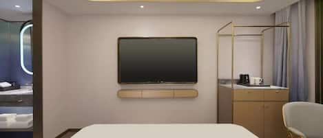 A modern hotel room with a large bed, a flat-screen TV mounted on the wall, a desk with a chair, and a wardrobe.