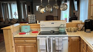 A kitchen with a stove, oven, and various kitchen appliances.