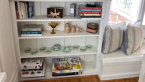 A bookshelf with books, decorative items, and a Star Wars box.
