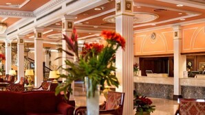 A lobby with a reception desk, seating area, and decorative plants. - Concorde El Salam Cairo Hotel & Casino (Cairo)