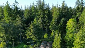 A lakeside property with multiple cabins, a dock, and a small house. - Jade Resort (Heriot Bay)