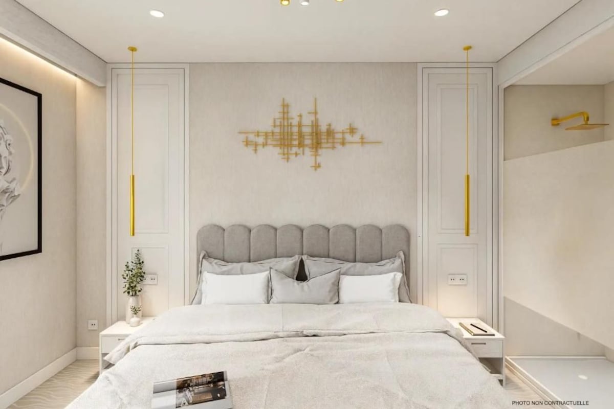 A modern bedroom with a large bed, a decorative wall piece, and a minimalist design.