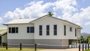 A two-story building with a flat roof and a number '35' on the side. - Reflections on the Tweed - Waterfront Pet Friendly Home with Boat Pontoon! Min. 3N - Linen Provided (South Murwillumbah)