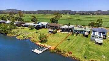 A residential area with houses, a dock, and a river.