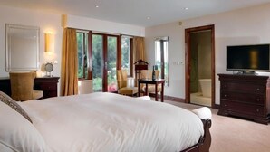 A bedroom with a large bed, a television, a dresser, a chair, and a desk. - Best Western Preston Garstang Country Hotel and Golf Club (Barnacre-with-Bonds)