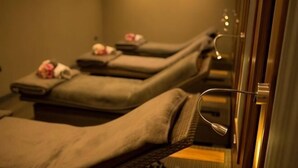 A row of massage therapy rooms with individual beds and towels. - Cbh Frensham Pond Hotel (Farnham)