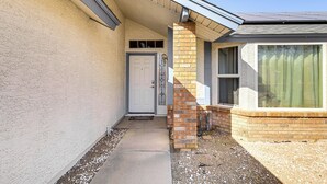 A house with a front door, a small porch, and a window.