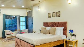 A bedroom with a large bed, a wooden nightstand, a ceiling fan, and a window with curtains.