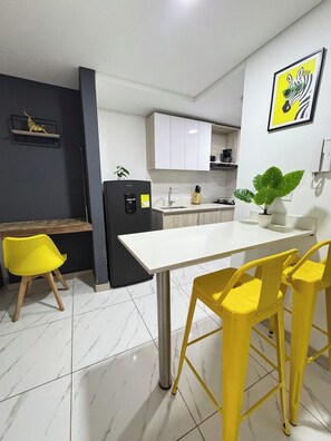 Fridge, microwave, coffee/tea maker, cookware/dishes/utensils