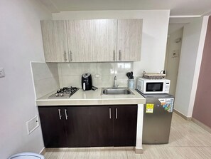 Fridge, stovetop, coffee/tea maker, cookware/dishes/utensils